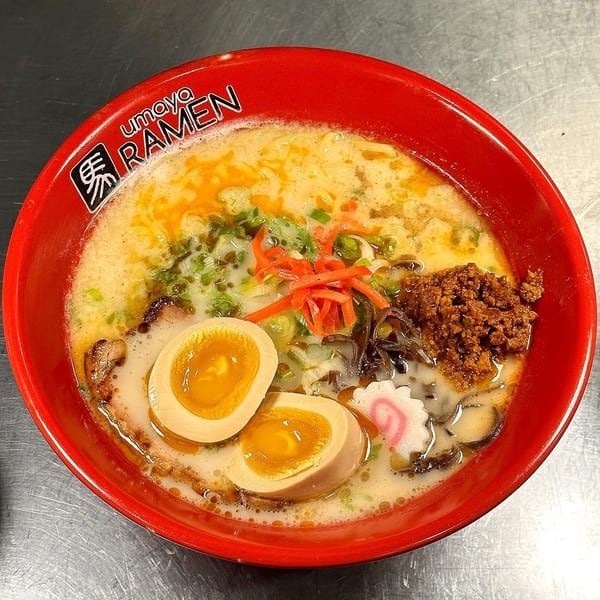 Umaya Ramen bowl with broth, noodles, two soft-boiled eggs, meat, and vegetables.